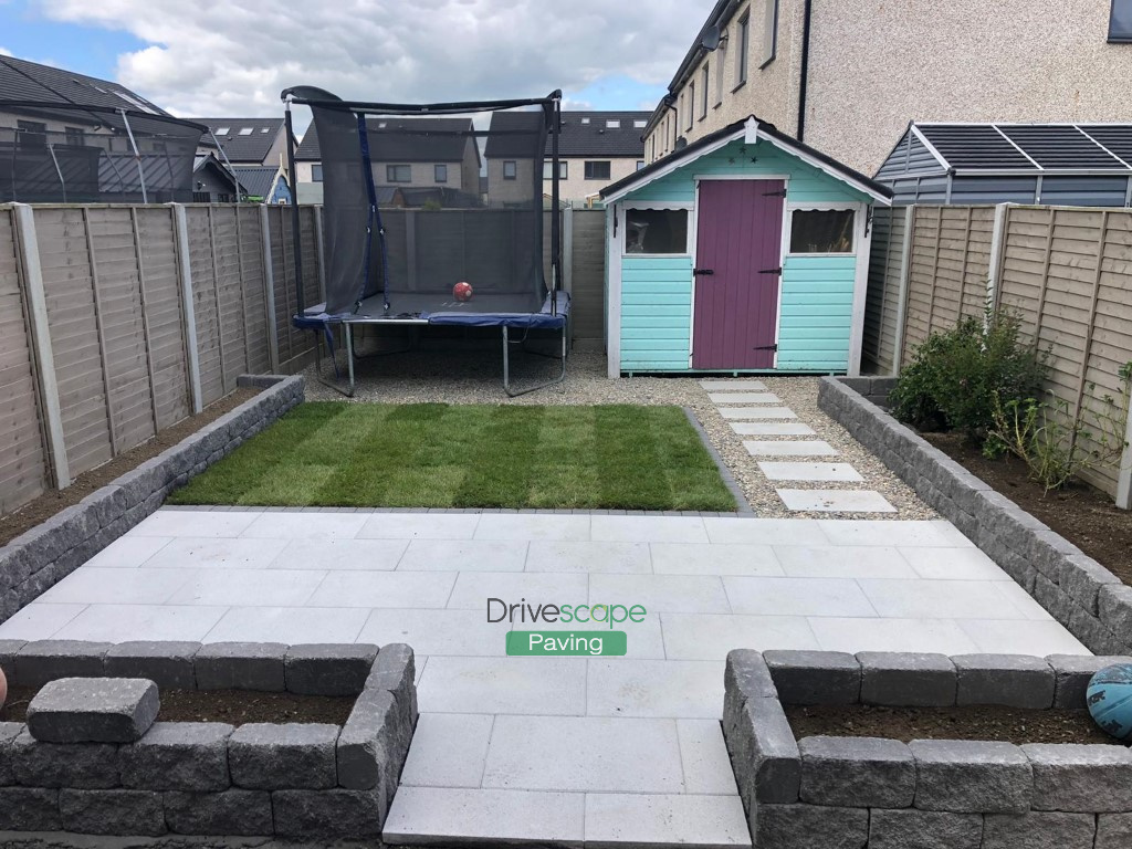 Slabbed Patio with Granite Borderline, Pebbled Pathway and Roll-On Turf in Hansfield Wood